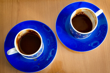 Top view of coffee cups. Coffee has been drunk. There are coffee grounds left in the cup. Coffee and fortune telling concept.