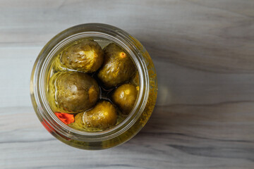 Pickled cucumbers in a jar.