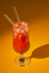 Strawberry punch cocktail on yellow