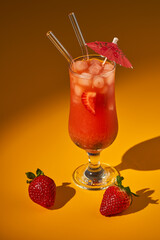 Strawberry punch cocktail on yellow
