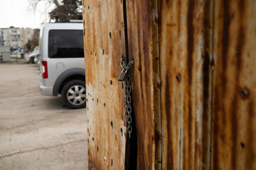 Rusty hut, a shack with a padlock on the door, an enclosed space used to store goods