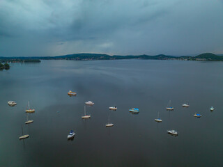Aerial sunrise waterscape with boats and an overcast sky