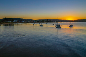 Aerial sunrise waterscape with boats and clear skies