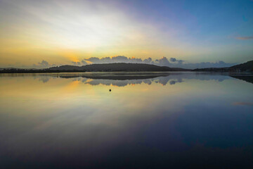 Hazy Sunrise Waterscape with Reflections