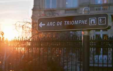 Street sign showing the way to landmark building of Arch of Triumph in Paris, France, during a...