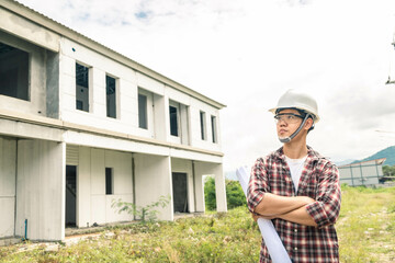 Young asian checking house with foreman engineering home inspection building house Walk home inspection with looking and pointing construction for check building home on job site to construction 2021