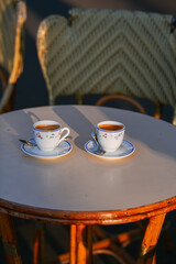 Two cups of espresso coffee on a coffee shop terrace from Paris, France.
