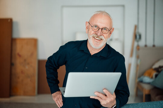 Happy Working Man With Laptop In Office