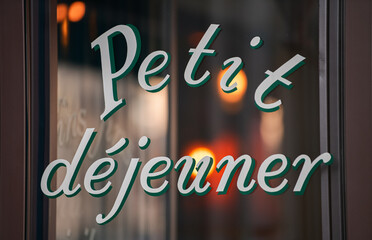 Petit dejeuner (breakfast) sign on the window of a pastry coffee shop in Paris, France.