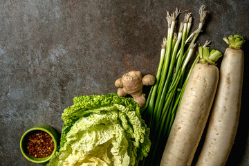 Ingredients for kimchi. Fresh vegetables, traditional Korean food in top view on wooden table copy space.