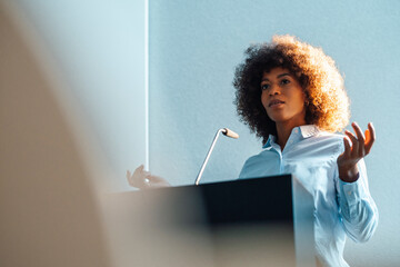 Businesswoman gesturing giving speech at work place