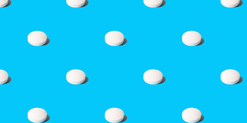 Large  white pills on a neon blue background. Seamless pattern for the background, minimalist...