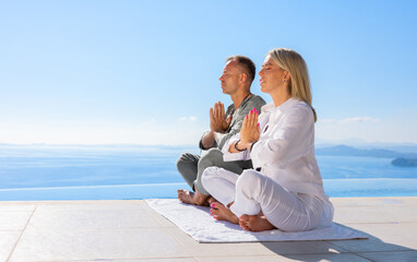 Couple practice meditation together  outdoors on terrace