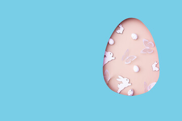 Easter egg cut out of paper and eggs, bunny and butterflies. Creative Easter holiday concept with copy space