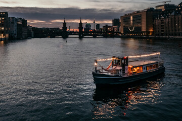 Illuminated boat on river at dusk