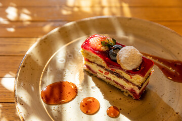Strawberry cake served on plate, ambient light, sunshine shadows