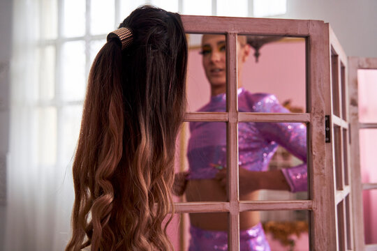 Non binary person getting dressed at home