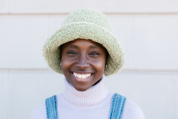 Trendy young african american woman smiling at camera outdoors - Cheerful millennial female student...
