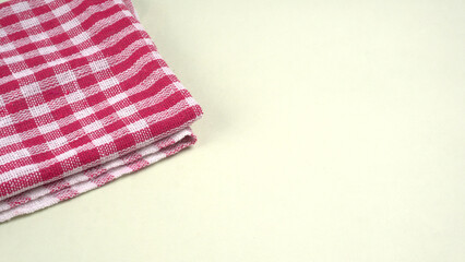 Folded kitchen textile towels of different colors, Household cleaning cloth. Closeup of cleaning rag isolated on a white background.
