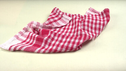 Folded kitchen textile towels of different colors, Household cleaning cloth. Closeup of cleaning rag isolated on a white background.
