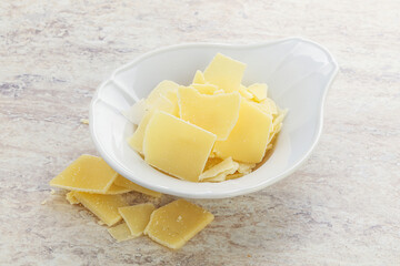 Sliced parmesan cheese heap in the bowl