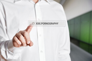 Man press the search bar icon on a virtual screen with the word pornography.