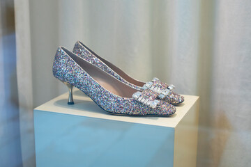 Sparkling shoes on a pedestal, beautiful shoes with rhinestones