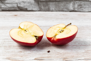 Two halves of an apple on the table. Cut apple in half. Photo