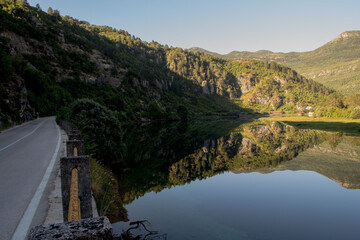 landscape with road, lake and mountains with wonderful reflection