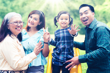 Three generation family takes photo in playground