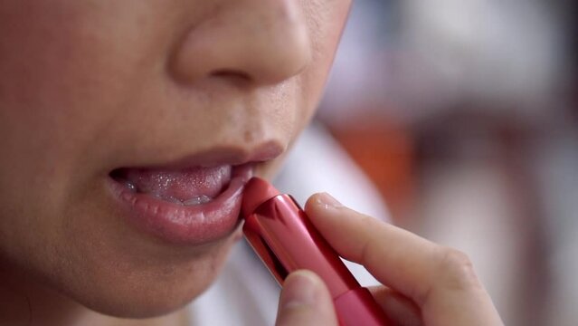 applying lipstick on Asian woman lip close-up slow motion
