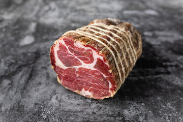 Capocollo of martina franca on marble table typical from apulia south italy. Italian salami
