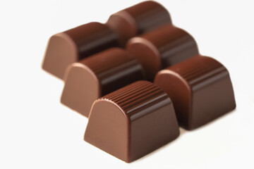 Milk chocolate cubes isolated on white background