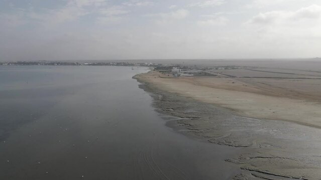 Low sandy Pacific coast port town in Peru called Paracas, aerial