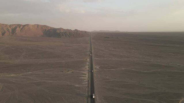 Aerial: Traffic on Pan American Highway near famous Nazca region, Peru