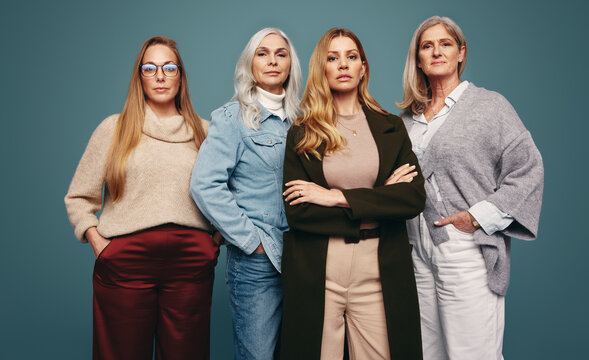 Empowered mature women standing together in a studio