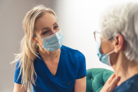 Professional Caregiver Patiently Takes Care Of Her Elderly Patient. High Quality Photo