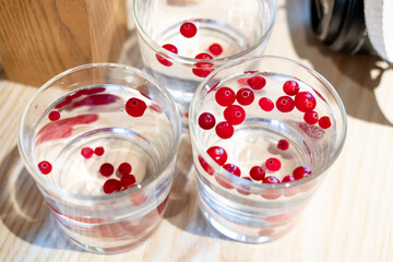 pure water with cranberries in a transparent glass.