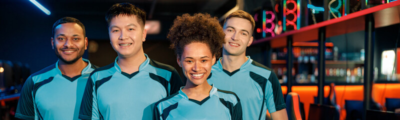 Team of four young multiracial professional cybersport gamers happy with their game while standing in contemporary e-sports club © Yaroslav Astakhov