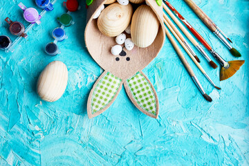 Fototapeta na wymiar Top view pack of eggs with brush, paint and decorative elements