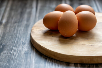 Fresh eggs on a wooden table, rustic background