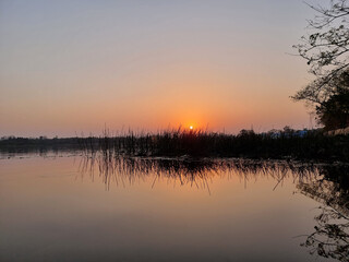 Evening sky and the glittering sun on the lake