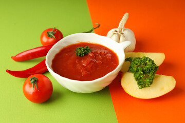 Concept of spicy sauce with Adjika on two tone background