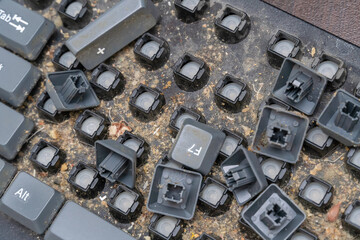 Close-up of a very dirty disassembled computer keyboard on the table. Disassembling a computer keyboard with your own hands, cleaning the keyboard