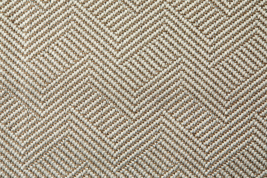 Knitted texture. Texture of jacquard fabric with gray geometric pattern. Crochet mosaic pattern.