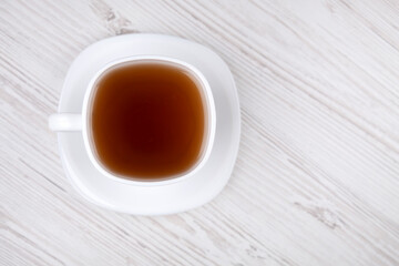 Black tea in a white cup, close-up.
