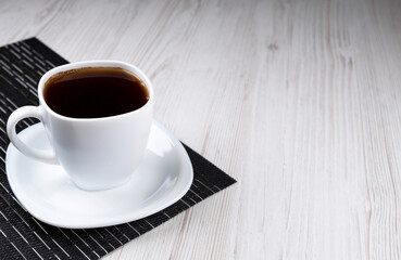 Cup of coffee on a black napkin