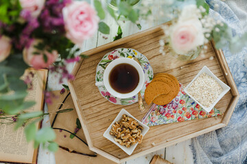 Overhead breakfast with flowers and books