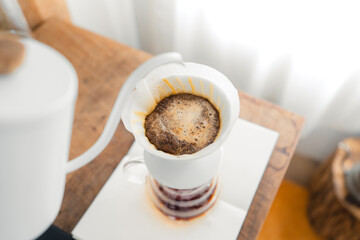Drip coffee,Pouring a hot water over a drip coffee on the table