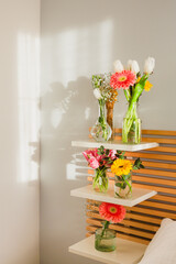 Bouquets of flowers in vases on a headboard at sunset